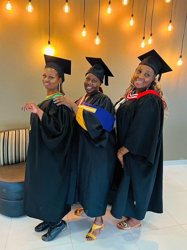 Three women in graduation caps and gowns
