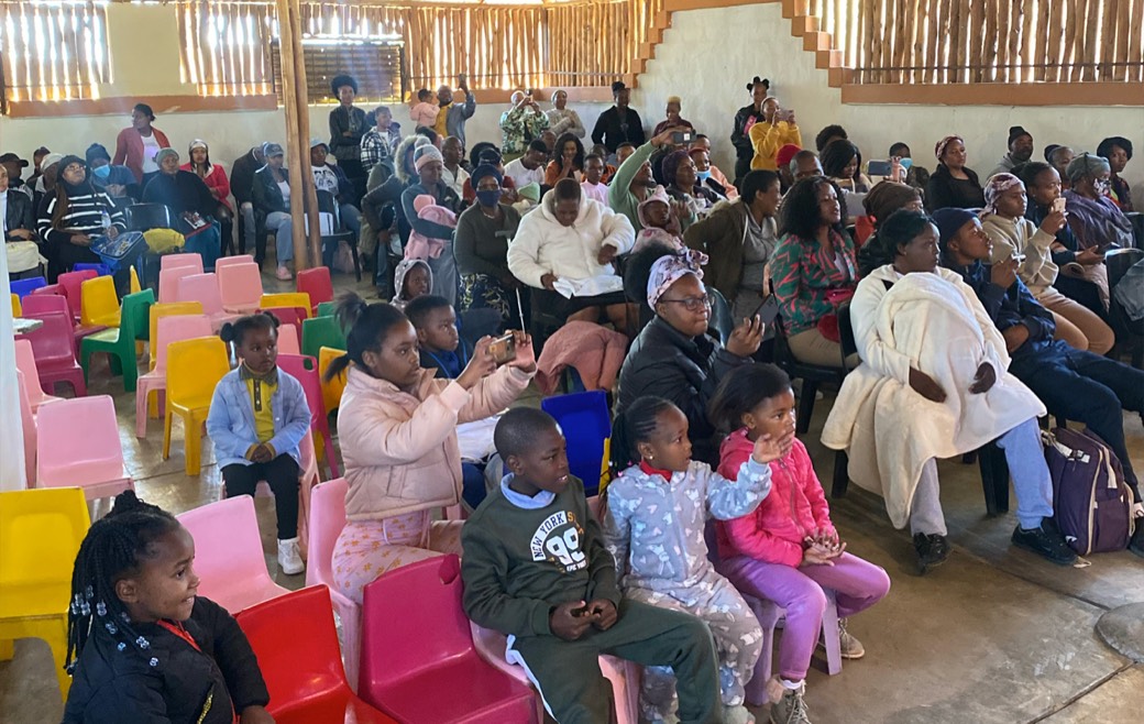 Families filling the Zonke Izizwe community hall for an event